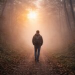 Persona caminando sola entre la niebla al amanecer, simbolizando la fe y la confianza en Dios durante la espera